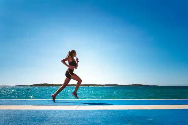 Woman running showing strong leg muscle Sonning